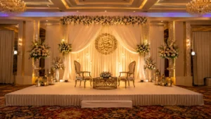 Decorated engagement party stage with floral backdrop and warm lighting at a banquet hall in Mississauga.