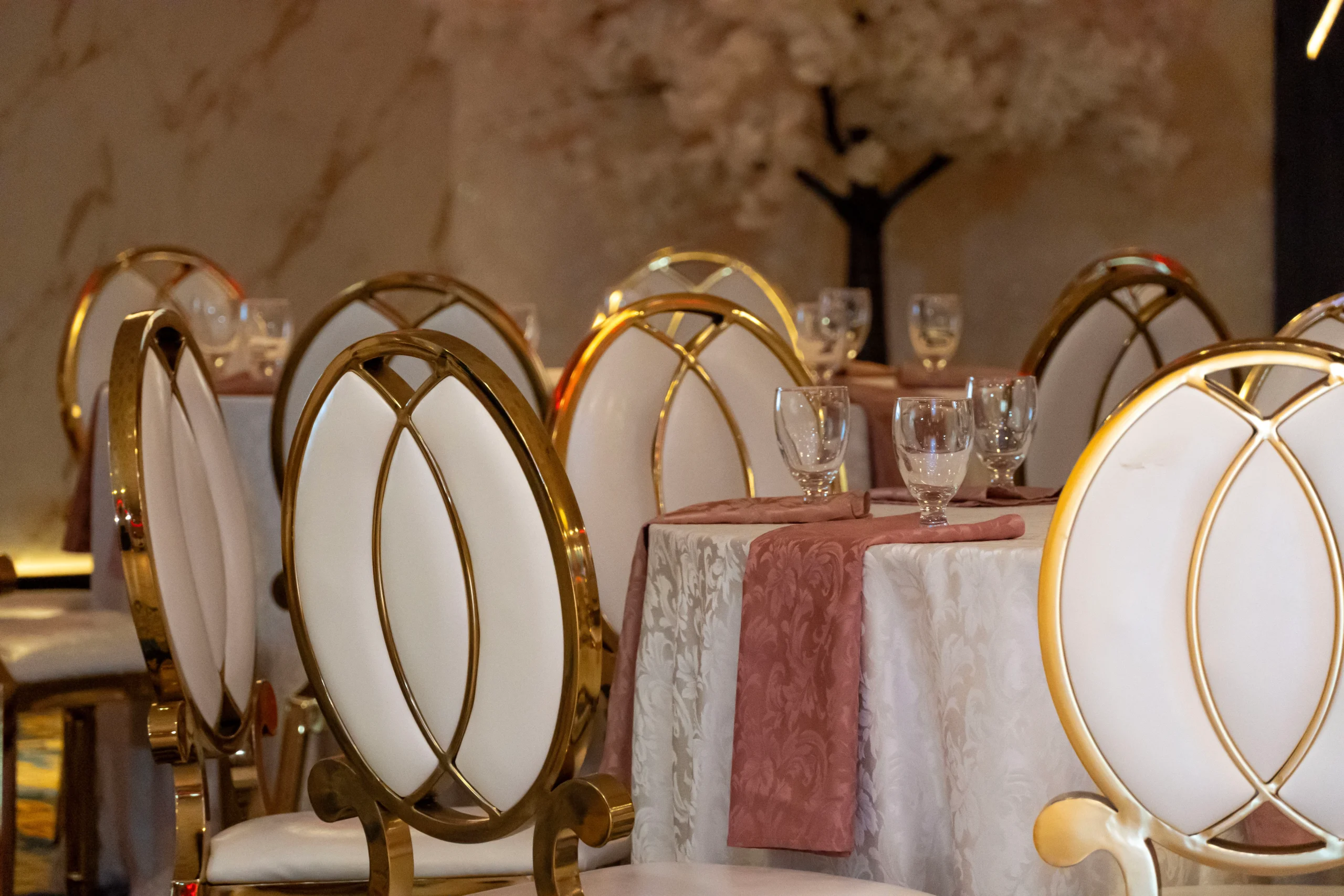 Elegant wedding reception buffet featuring appetizers, main courses and desserts inside a decorated banquet hall.